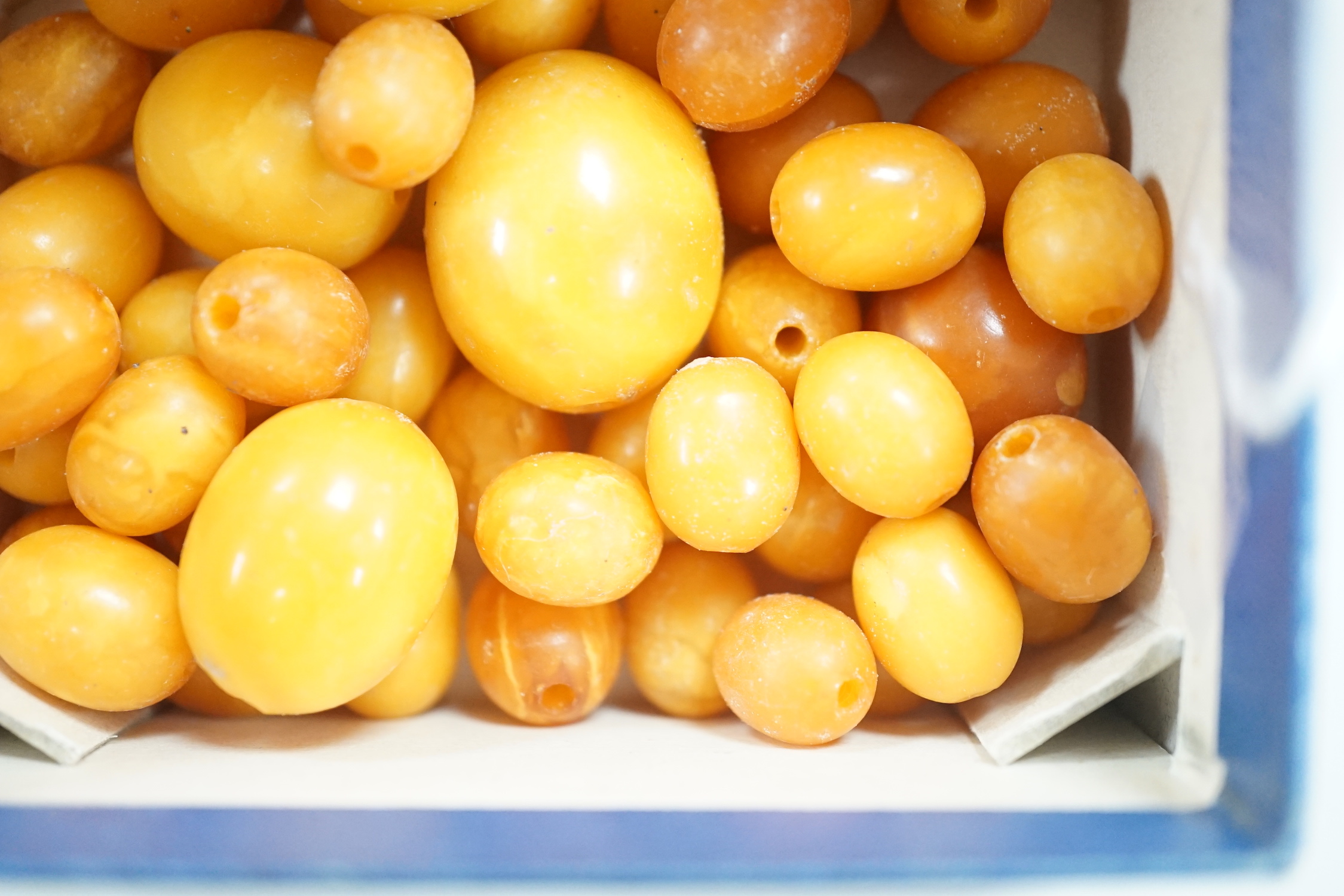 A group of loose graduated oval amber beads, 42 grams.